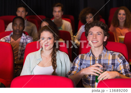 Young couple watching a film Young couple watching a film 13689200