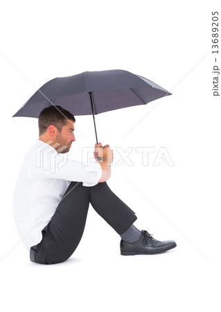 Businessman sitting on the floor with black umbrella 13689205
