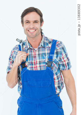 Confident plumber holding tool over white background Confident plumber holding tool over white background 13689302