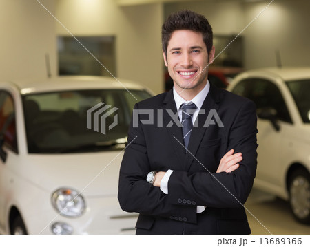 Smiling businessman standing with arms crossed Smiling businessman standing with arms crossed 13689366