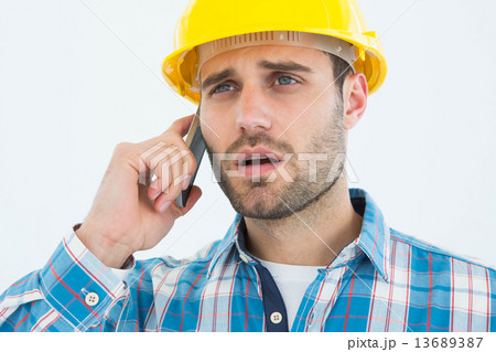 Carpenter using cellphone 13689387