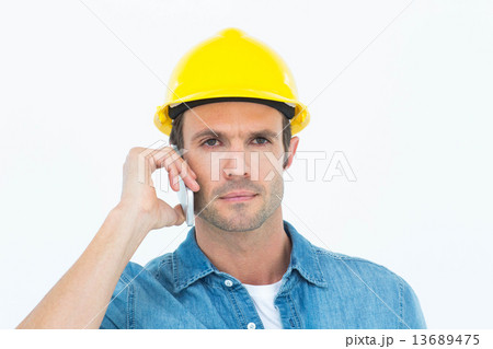 Serious carpenter using mobile phone Serious carpenter using mobile phone 13689475