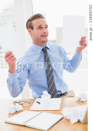 Cheerful businessman showing documents Cheerful businessman showing documents 13689702