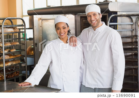 Team of bakers smiling at camera Team of bakers smiling at camera 13690091