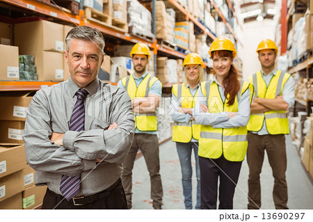 Smiling warehouse team with arms crossed 13690297
