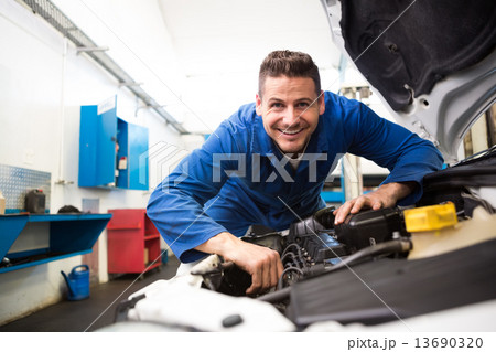 Mechanic working under the hood Mechanic working under the hood 13690320