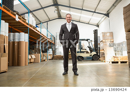 Warehouse manager standing with hands in the pocket 13690424