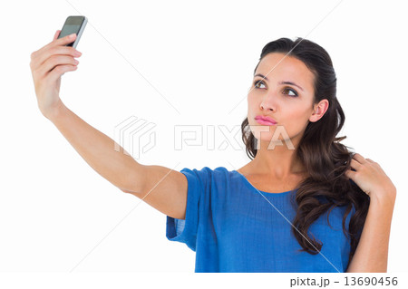 Pretty brunette taking a selfie 13690456