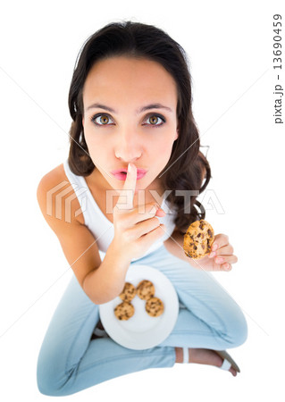 Pretty brunette eating plate of cookies 13690459
