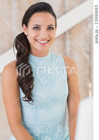 Stylish brunette smiling at camera Stylish brunette smiling at camera 13690665