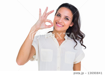 Pretty brunette making ok sign 13690841