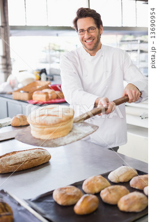 Baker showing freshly baked loaf Baker showing freshly baked loaf 13690954