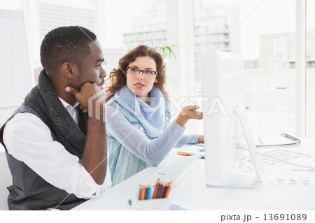 Concentrated teamwork interacting and using computer 13691089