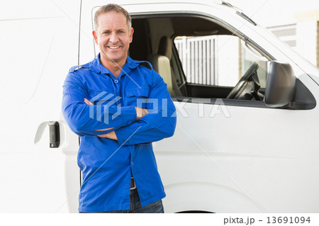Smiling man in front of delivery van 13691094