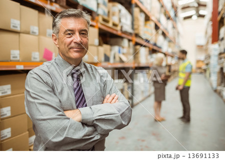 Smiling businessman with crossed arms Smiling businessman with crossed arms 13691133