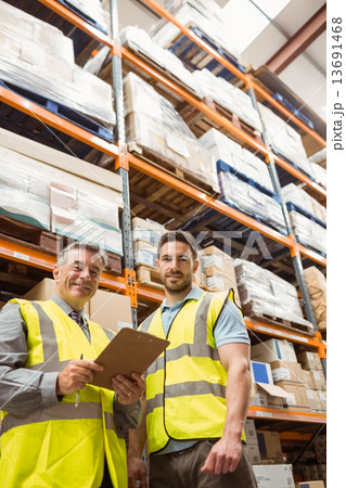 Warehouse manager and foreman looking at camera Warehouse manager and foreman looking at camera 13691468