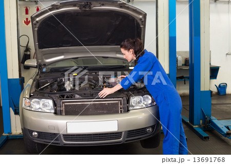 Mechanic working under the hood Mechanic working under the hood 13691768