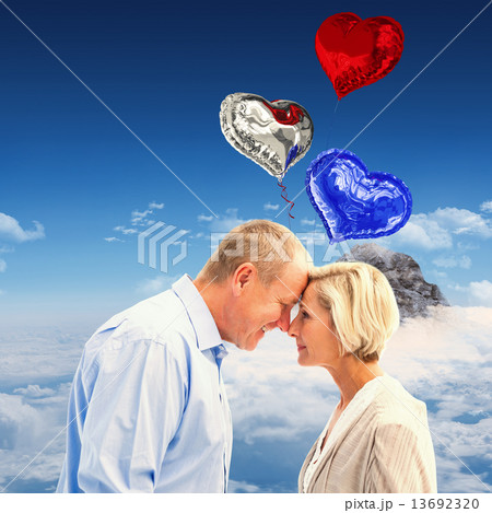 Composite image of happy mature couple facing each other 13692320