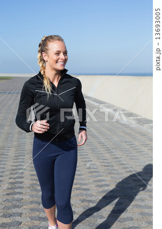 Fit blonde jogging on the pier 13693005