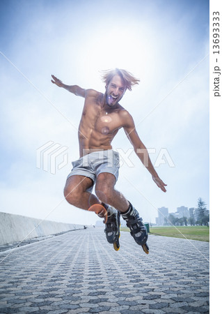 Fit man rollerblading on the promenade 13693333