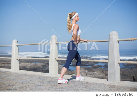 Fit woman stretching on the pier 13693560
