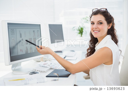 Smiling businessman pointing her computer Smiling businessman pointing her computer 13693623