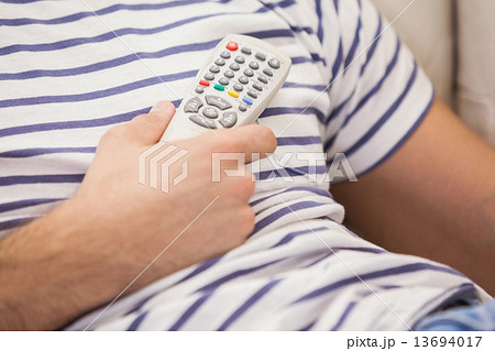 Close up of cute couple watching tv on the couch 13694017