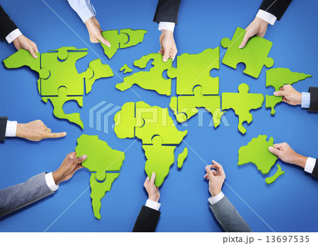 Group of Business People with Jigsaw Puzzle Forming in World Map Group of Business People with Jigsaw Puzzle Forming in World Map 13697535