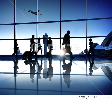 Business People On Their Way To The Business Trip Walking In An Business People On Their Way To The Business Trip Walking In An 13699005