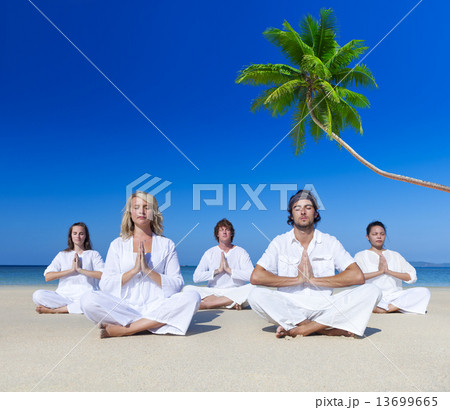 People performing yoga on the beach 13699665