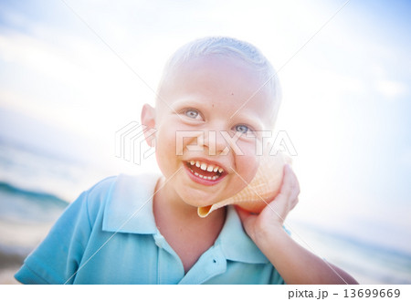 Little boy having fun on a beach 13699669