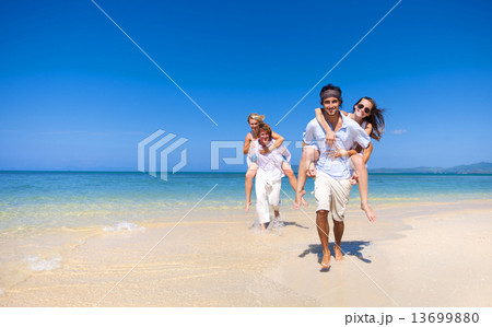 Two couple relaxing on the beach 13699880