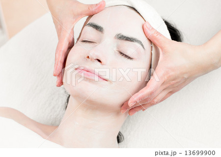 Young woman facial massage in beauty parlour 13699900