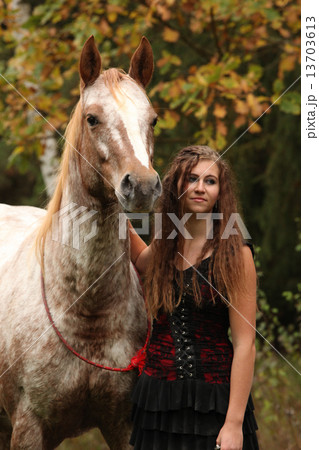 Amazing girl standing next to the appaloosa horse Amazing girl standing next to the appaloosa horse 13703613