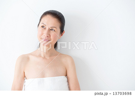 ナチュラルメイクの50代女性 バスタオル 上半身の写真素材