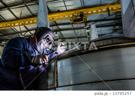 Man welding with reflection of sparks on visor. Hard job. Man welding with reflection of sparks on visor. Hard job. 13705257