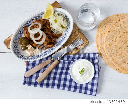 Gyros with Tzatziki Coleslaw olives and feta cheese 13705489