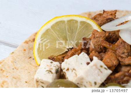 Gyros pita with tzatziki coleslaw olives and feta cheese 13705497