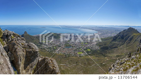 View from the flat top of Cape Town's Table Mountain. Views of Cape Town city, Atlantic ocean, harbor and Lion's Head hiking peak can be seen from the various cliff orientated mountain outlooks. 13706544