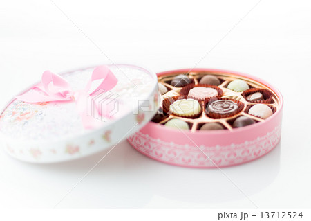 Chocolates in pink box on white background 13712524