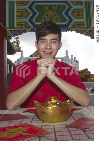 Man with assortment of CNY items 13718490