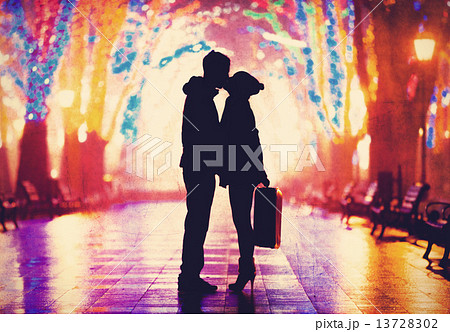 Couple with suitcase kissing at night alley. Couple with suitcase kissing at night alley. 13728302