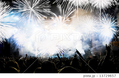 New Year concept - cheering crowd and fireworks 13729657