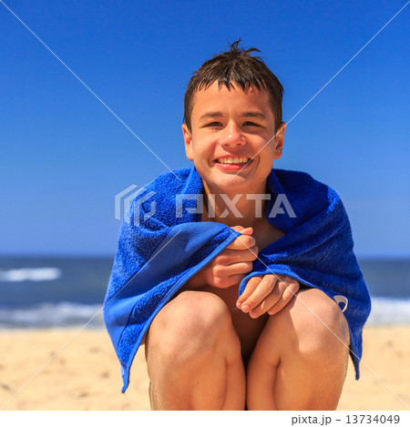 Happy young boy on the sea beach Happy young boy on the sea beach 13734049
