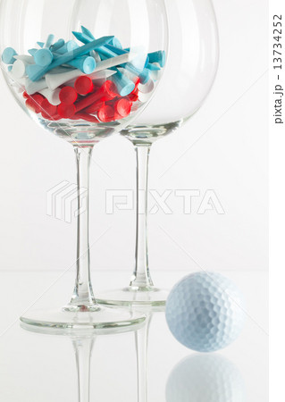 Two glasses of wine and golf equipments Two glasses of wine and golf equipments 13734252