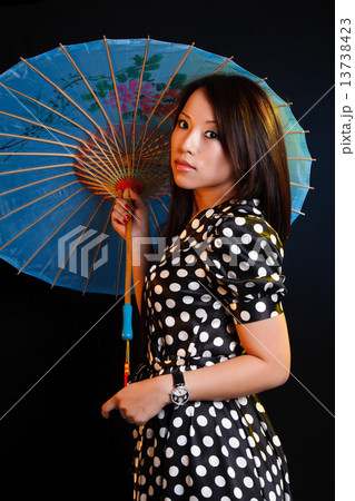 Youn asian woman with umbrella Youn asian woman with umbrella 13738423