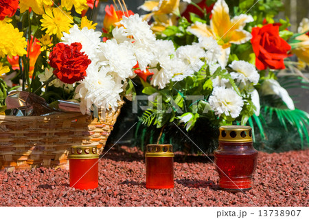 Candles and flowers at cemetery 13738907