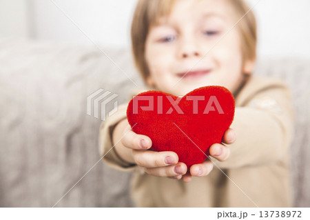 Сute young boy with a red heart Сute young boy with a red heart 13738972