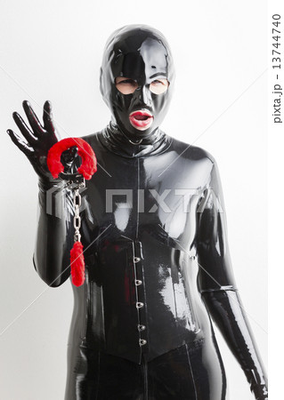 portrait of woman wearing latex clothes with handcuffs portrait of woman wearing latex clothes with handcuffs 13744740