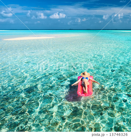 Woman relaxing on inflatable mattress 13746326